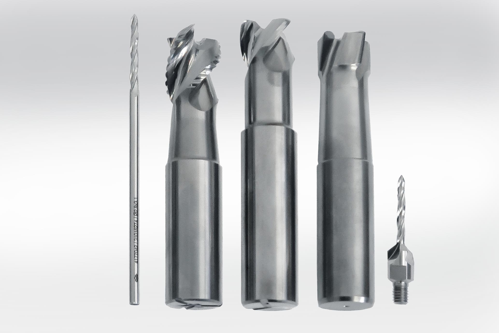 There are five tools in the row: Reamer, 2 milling cutters, PCD high-feed milling cutter, combination tool for drilling/countersinking. 