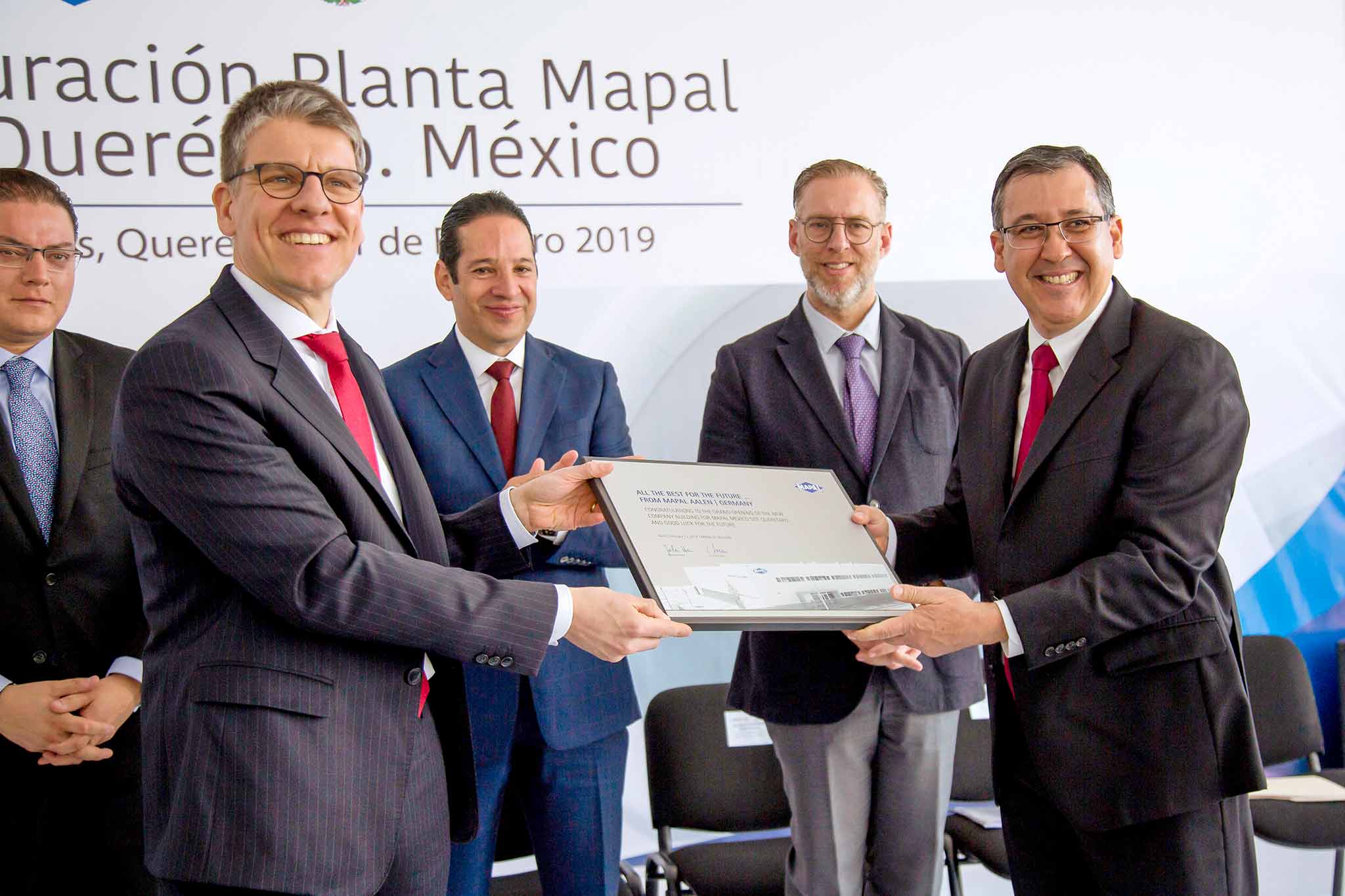 In the foreground, Dr Jochen Kress hands over a commemorative plaque to Lazaro Garza Sr. at the opening of the site. 