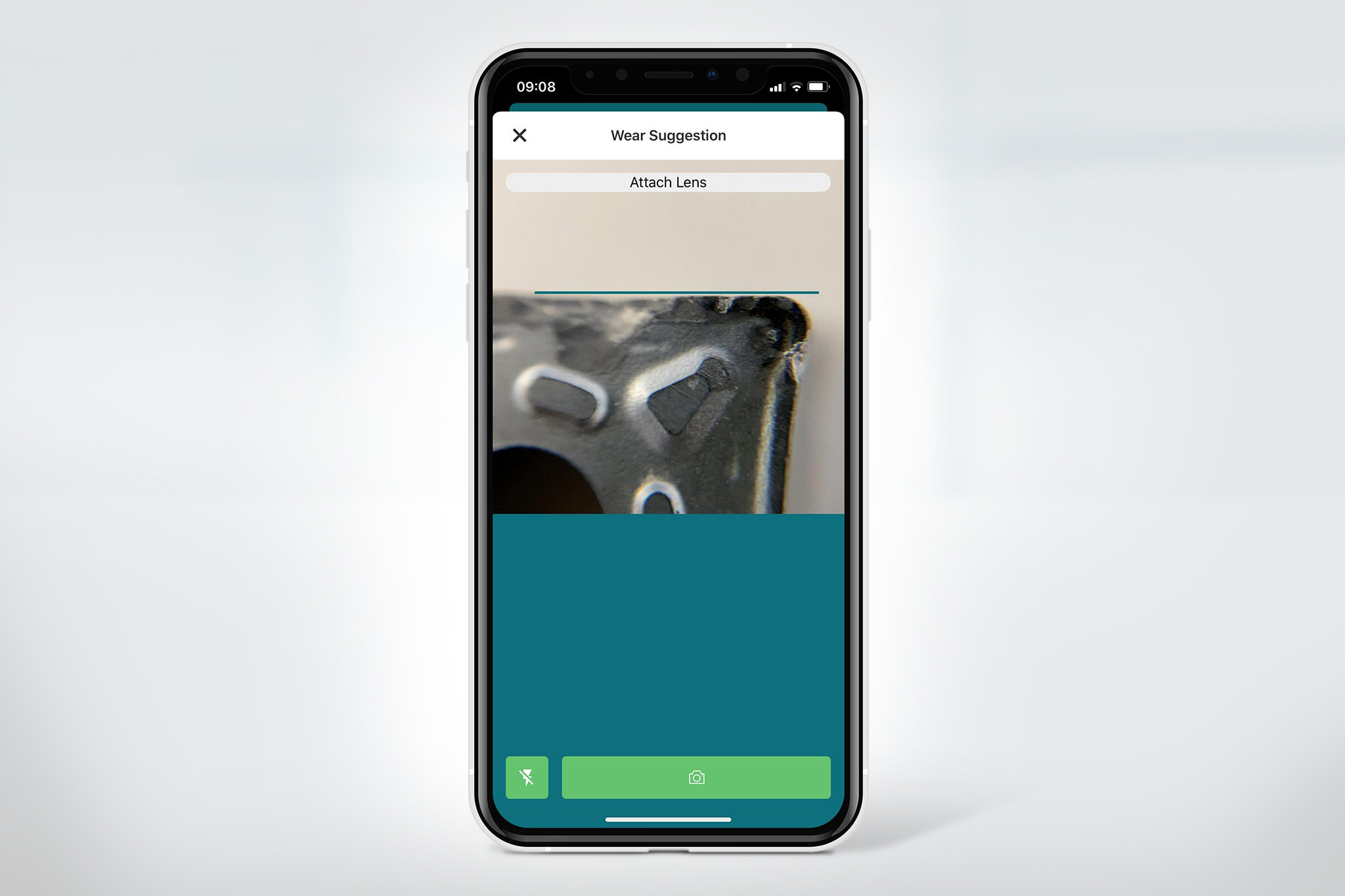 A mobile phone with an open c-Com wear and tear detection app with a photographed worn cutting edge.