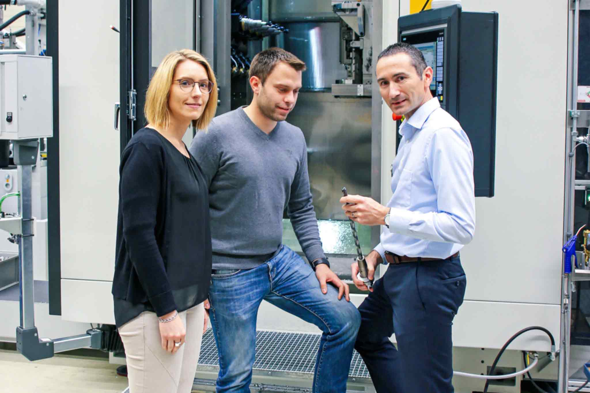 Carina Becker (left) and Jörg Rodehutskors (centre) in conversation with Alexander Wiesner in front of an FM3+X hd manufacturing module.