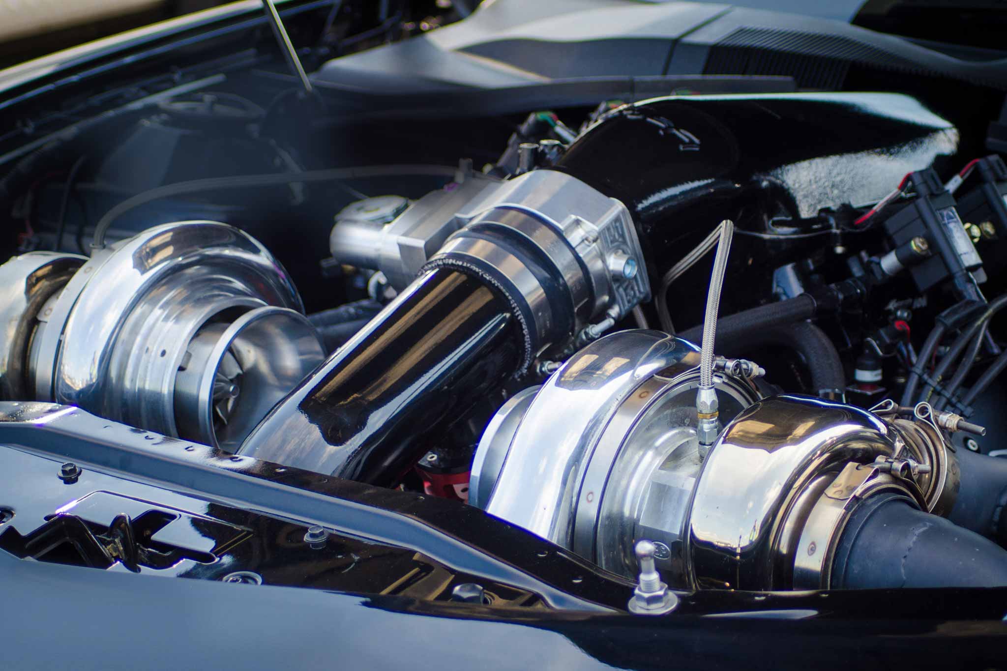 A view into the engine compartment of a car with turbocharger.