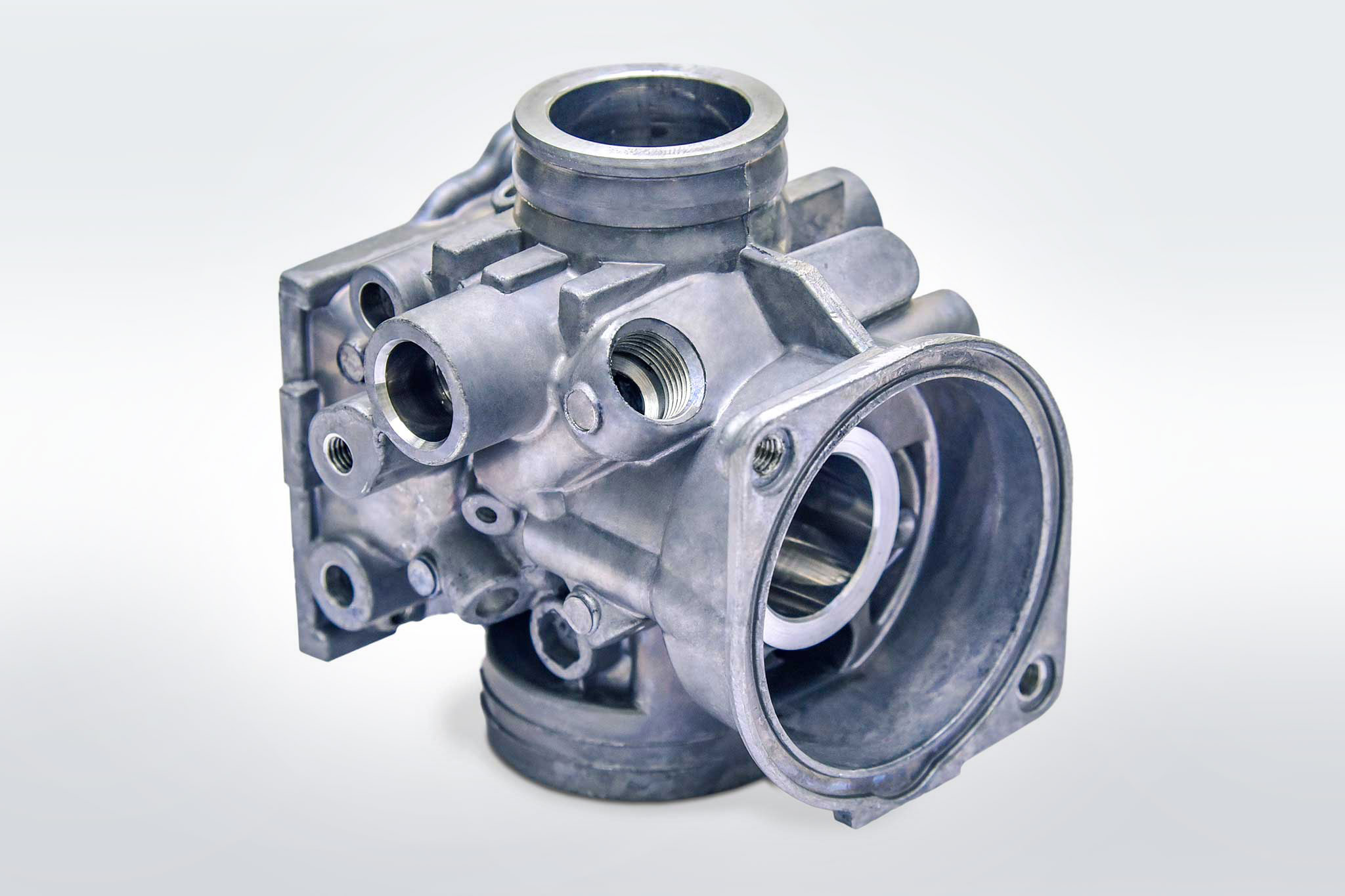 A carburettor housing is shown in the image.